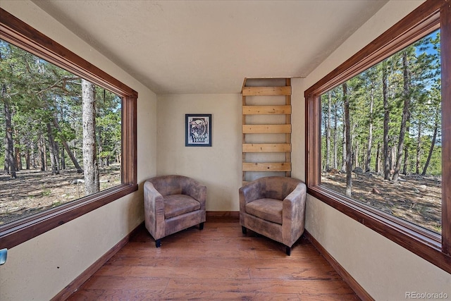 sitting room with hardwood / wood-style flooring and baseboards