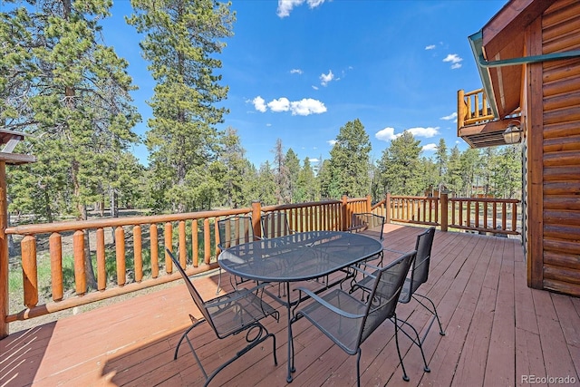 wooden deck featuring outdoor dining area