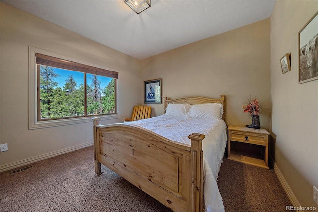 carpeted bedroom with baseboards and visible vents