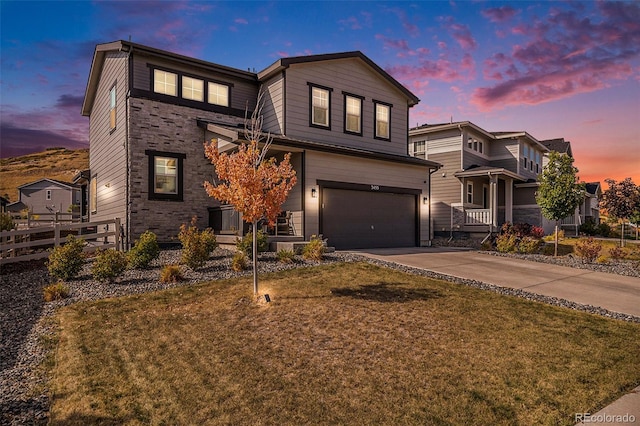 view of front of house with a garage and a lawn