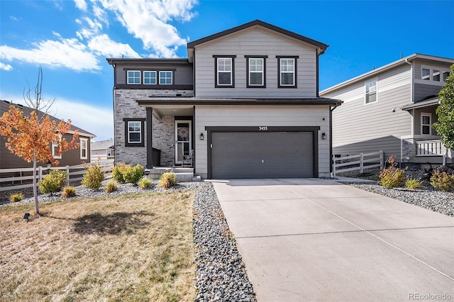 view of property featuring a garage and a front lawn