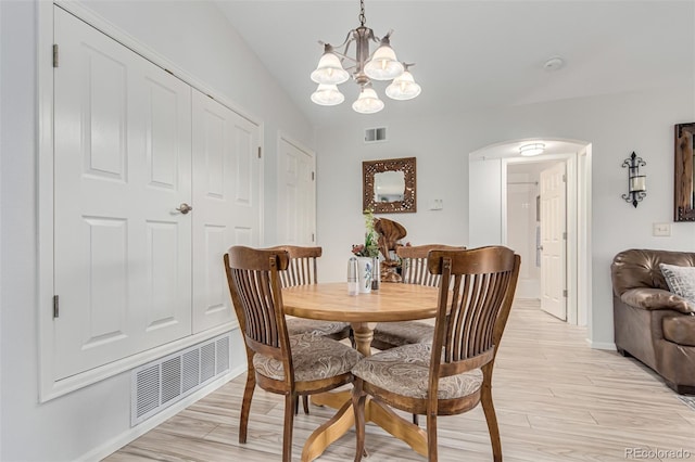 dining area with a chandelier and light hardwood / wood-style floors