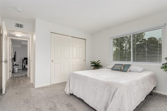 carpeted bedroom with a closet