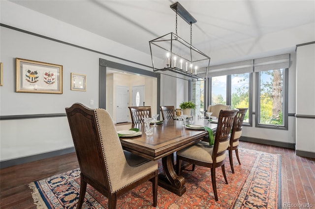 dining space featuring a chandelier and dark wood-type flooring