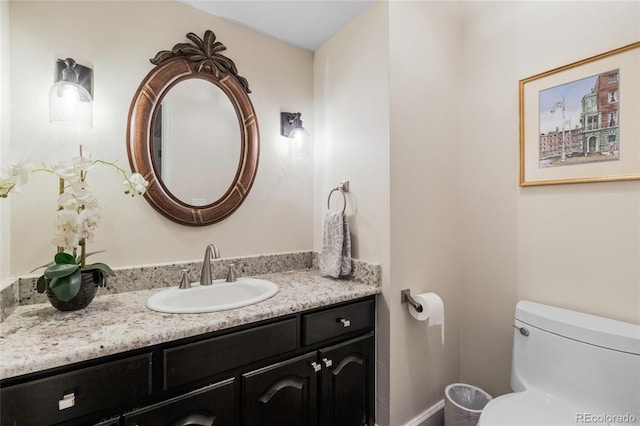 bathroom featuring vanity and toilet