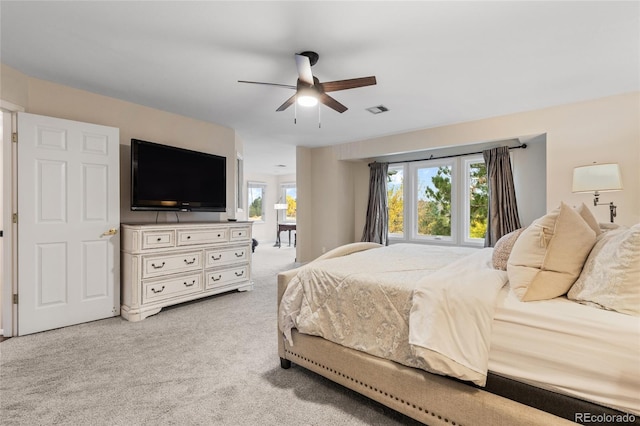 bedroom with ceiling fan and light carpet