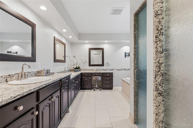 bathroom with plus walk in shower, vanity, and tile patterned floors