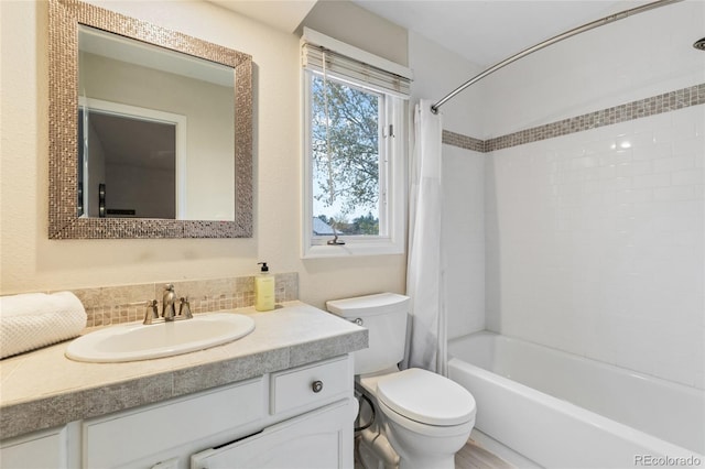 full bathroom with vanity, toilet, backsplash, and shower / tub combo