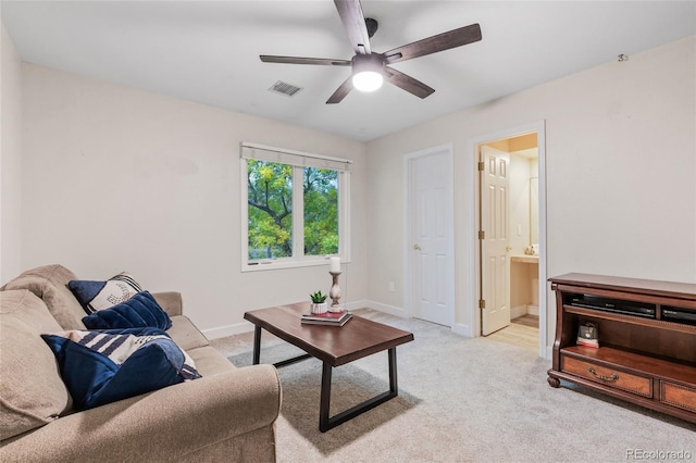 carpeted living room featuring ceiling fan