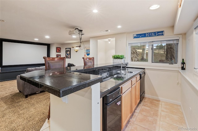 kitchen with sink, kitchen peninsula, a breakfast bar area, light carpet, and light brown cabinetry