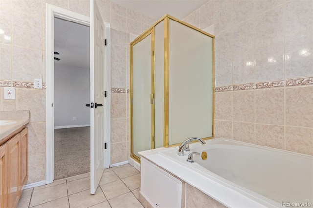 4935 Apollo Bay Dr, Highlands Ranch, CO 80130 - full bath featuring tile walls, a stall shower, a garden tub, tile patterned flooring, and vanity