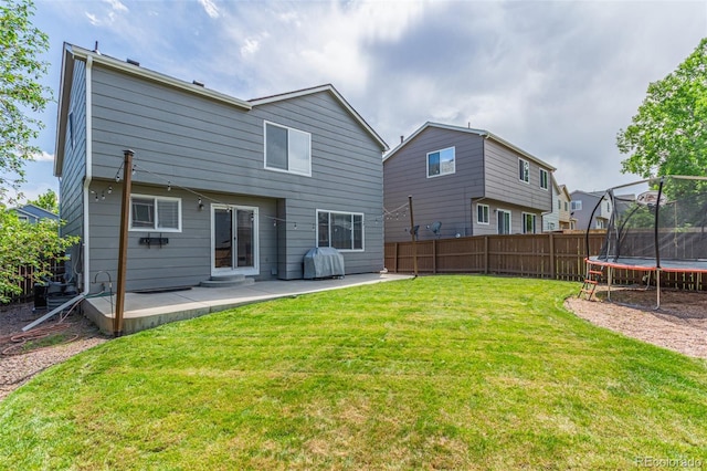 4935 Apollo Bay Dr, Highlands Ranch, CO 80130 - back of property featuring a trampoline and a patio