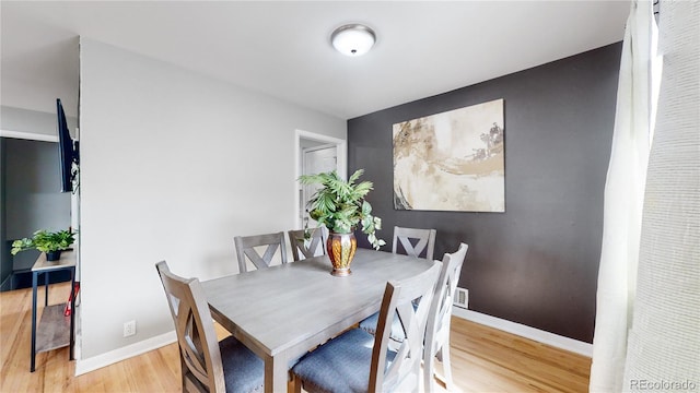 dining area with light hardwood / wood-style flooring