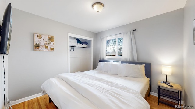 bedroom with hardwood / wood-style floors