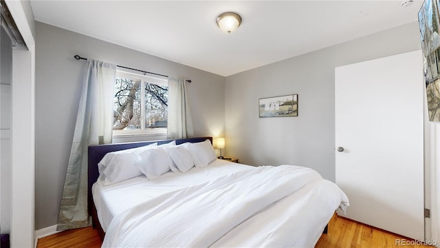 bedroom with hardwood / wood-style floors