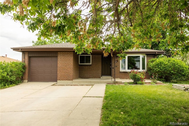 654 S Shoshone St, Denver, CO 80223 - single story home with a garage, driveway, brick siding, and a front yard