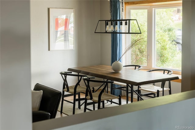 654 S Shoshone St, Denver, CO 80223 - dining area with plenty of natural light and a chandelier