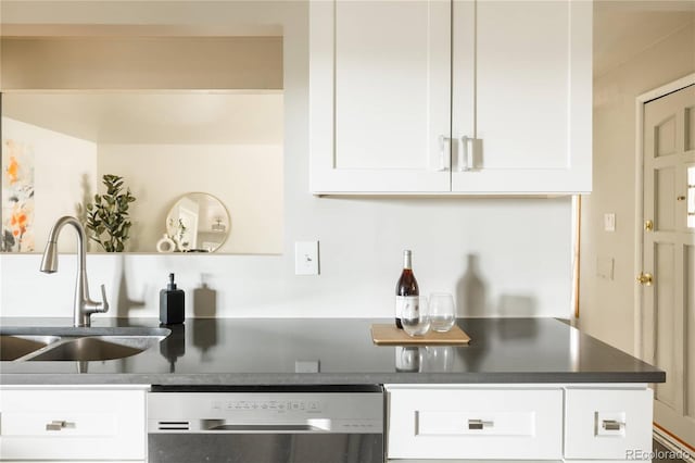 654 S Shoshone St, Denver, CO 80223 - kitchen with dishwasher, a sink, dark countertops, and white cabinets