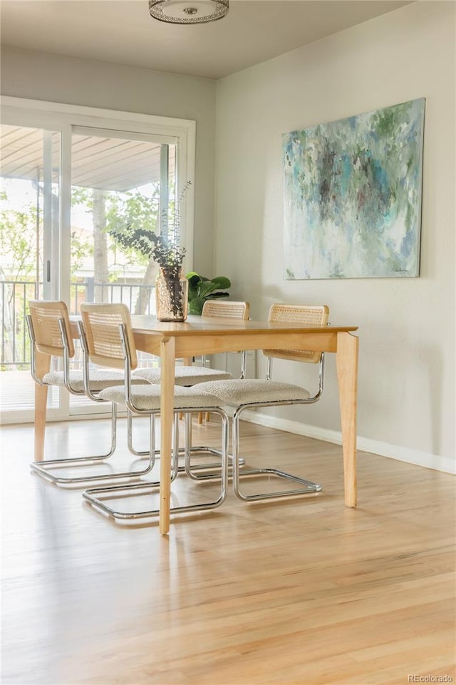654 S Shoshone St, Denver, CO 80223 - dining area with wood finished floors and baseboards