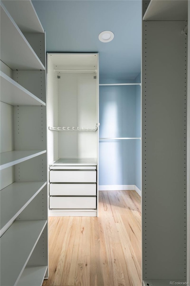 654 S Shoshone St, Denver, CO 80223 - spacious closet featuring wood finished floors