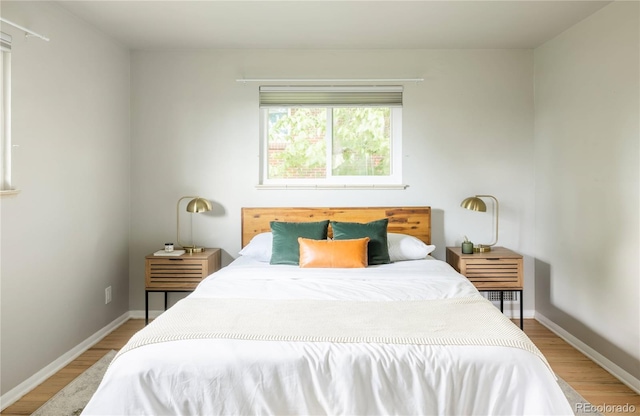 654 S Shoshone St, Denver, CO 80223 - bedroom with light wood-type flooring and baseboards
