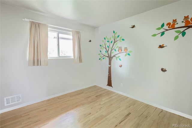 654 S Shoshone St, Denver, CO 80223 - unfurnished room with wood finished floors and baseboards
