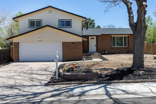 3256 S Nucla St, Aurora, CO 80013 - tri-level home featuring fence, brick siding, driveway, and a garage