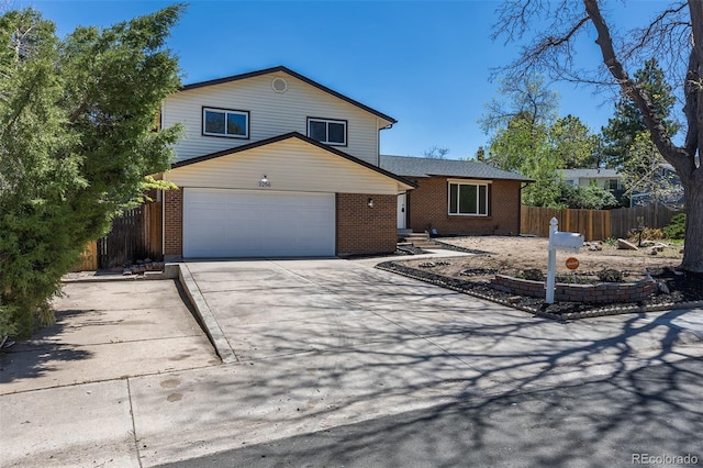 3256 S Nucla St, Aurora, CO 80013 - tri-level home with fence, driveway, and brick siding