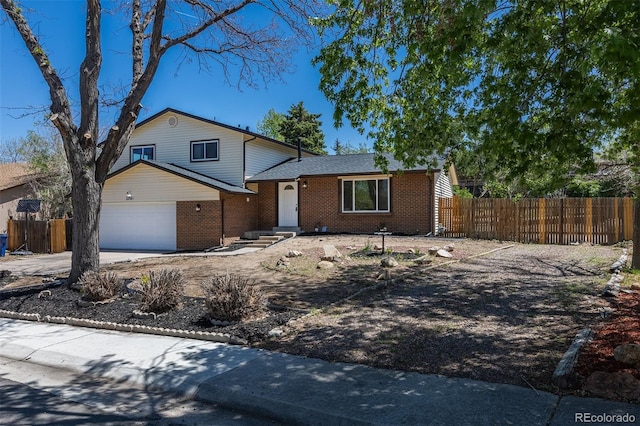 3256 S Nucla St, Aurora, CO 80013 - tri-level home with fence, brick siding, concrete driveway, an attached garage, and roof with shingles