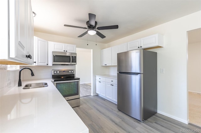 3256 S Nucla St, Aurora, CO 80013 - kitchen with appliances with stainless steel finishes, a sink, light countertops, and white cabinets