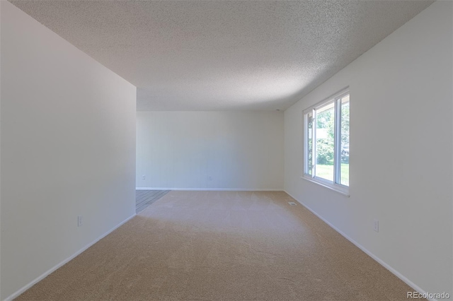 3256 S Nucla St, Aurora, CO 80013 - empty room with light carpet, a textured ceiling, and baseboards