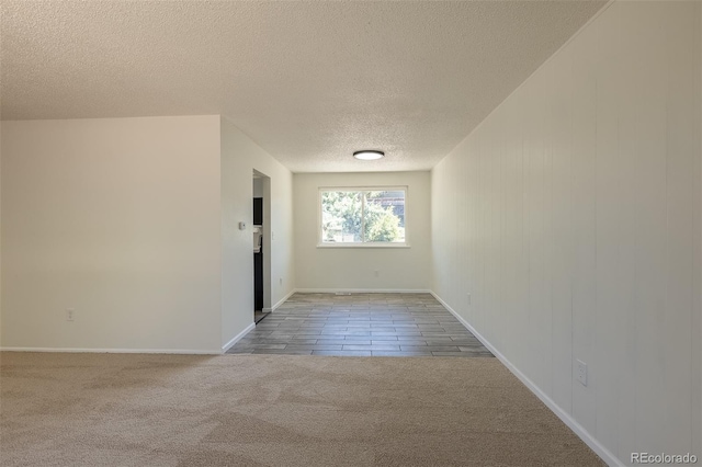 3256 S Nucla St, Aurora, CO 80013 - unfurnished room with a textured ceiling, carpet, baseboards, and tile patterned flooring
