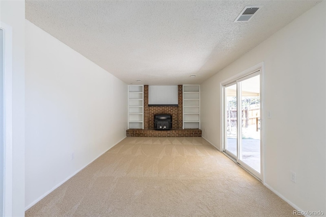 3256 S Nucla St, Aurora, CO 80013 - unfurnished living room with light colored carpet, a textured ceiling, built in features, and baseboards