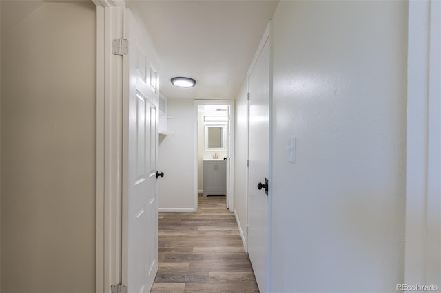 3256 S Nucla St, Aurora, CO 80013 - hall with wood finished floors, baseboards, and a sink