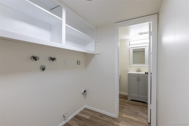 3256 S Nucla St, Aurora, CO 80013 - laundry room with gas dryer hookup, wood finished floors, and baseboards