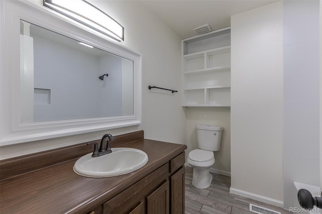 3256 S Nucla St, Aurora, CO 80013 - full bath featuring toilet, wood finished floors, vanity, baseboards, and a shower