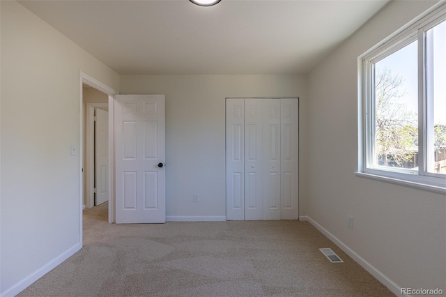 3256 S Nucla St, Aurora, CO 80013 - unfurnished bedroom featuring light colored carpet, baseboards, and a closet