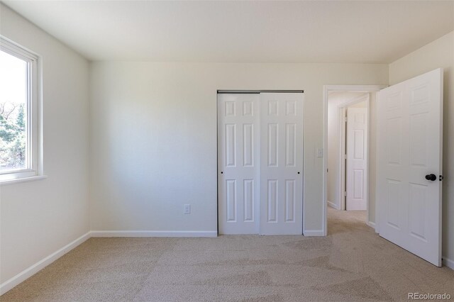 3256 S Nucla St, Aurora, CO 80013 - unfurnished bedroom featuring light carpet, a closet, and baseboards
