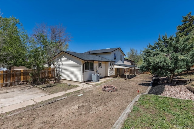 3256 S Nucla St, Aurora, CO 80013 - rear view of house featuring a fire pit, fence, central AC, and a patio