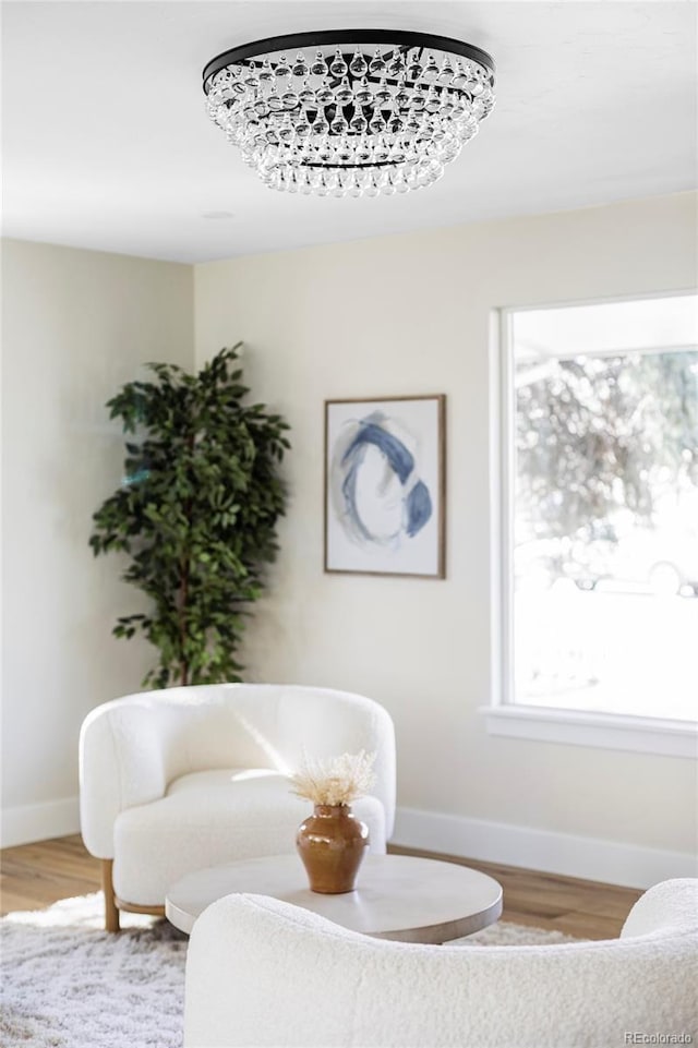 sitting room featuring baseboards and wood finished floors