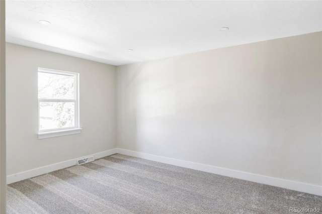empty room with light carpet and baseboards