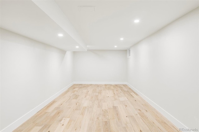 finished below grade area with recessed lighting, light wood-style flooring, and baseboards