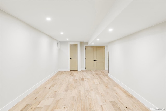 finished basement featuring recessed lighting, baseboards, and light wood-style floors