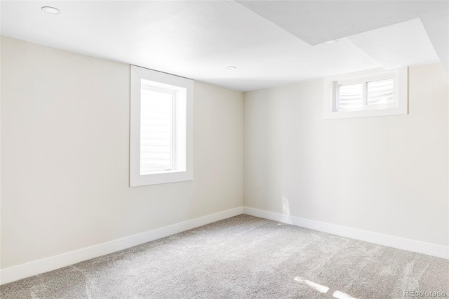 below grade area featuring carpet and baseboards