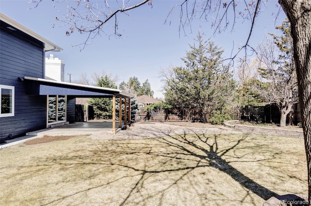 view of yard with fence and a patio