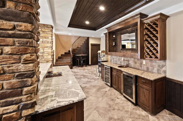 bar featuring wine cooler, stairway, wood ceiling, a tray ceiling, and indoor wet bar