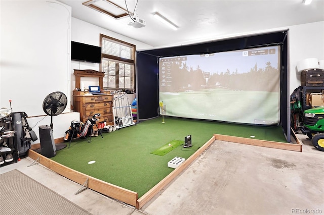 rec room featuring concrete floors and golf simulator