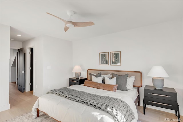 bedroom with light hardwood / wood-style flooring and ceiling fan