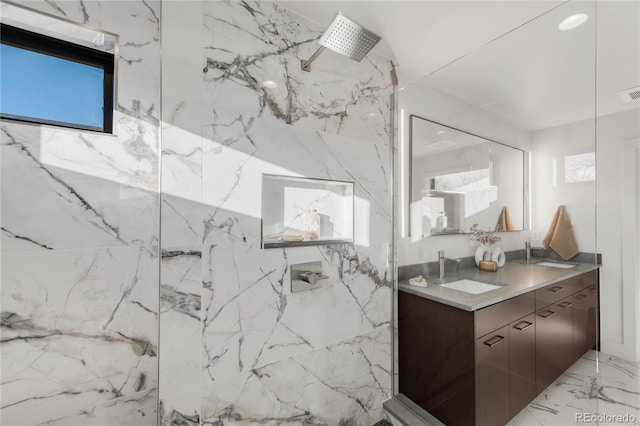 bathroom with a shower and vanity