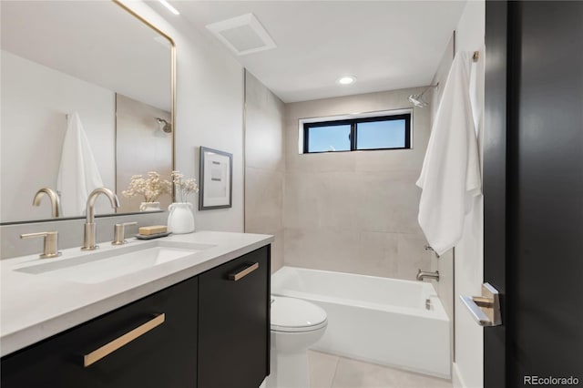 full bathroom with tiled shower / bath, vanity, toilet, and tile patterned flooring